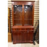 A 20th Century mahogany glazed bookcase.