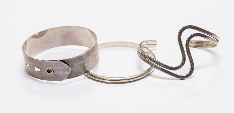 A group of three silver bangles, including torque, hinged and slip on versions (1 bag)