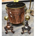A large copper and brass log bucket with chinoserie design and a pair of copper and brass and irons