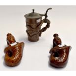 A pair of stone ware figures, 19th Century, mermaids along with a late 19th Century Stein with grape