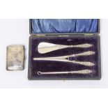 A silver ladies button hook, shoe horn, glove stretcher set boxed along with a silver cigarette case