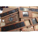 Two boxes of glass magic lantern slides, some painted, one box packed up in 1938!