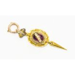 A Victorian garnet, enamel and seed pearl pendant, comprising a centrally set cabochon garnet with