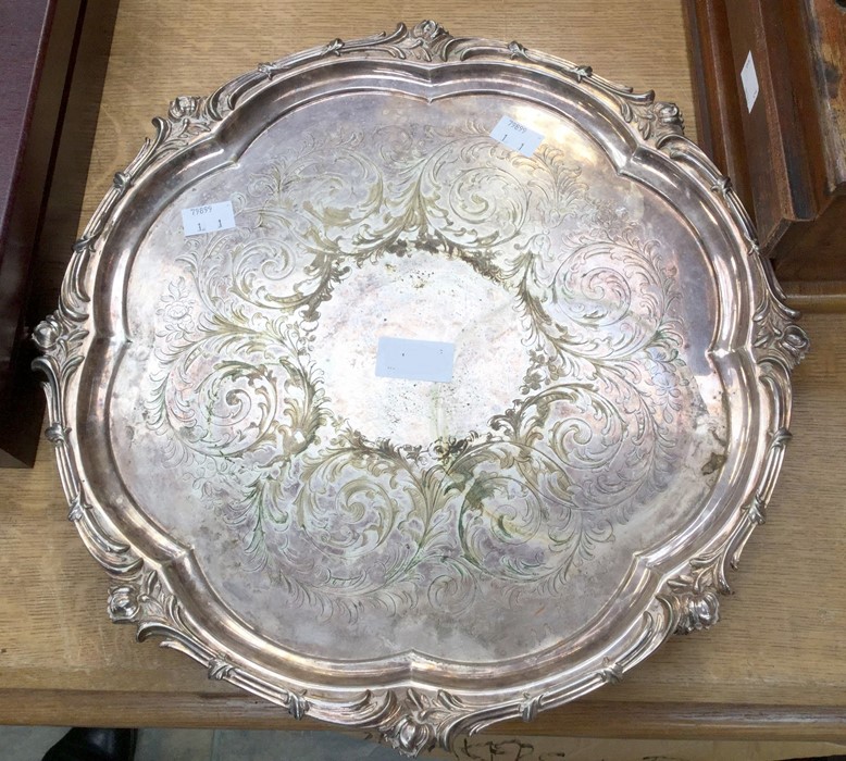 An Elkington & Co silver plated circular tray with raised leafage border and four pierced scroll