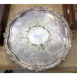 An Elkington & Co silver plated circular tray with raised leafage border and four pierced scroll