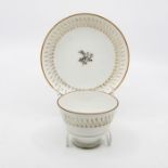 Derby Sevres marked tea bowl and saucer, circa 1840, white ground with gold decoration Condition: