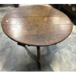 A George II oak tilt top table on turned tripod pedestal base with elongated feet. Diameter approx