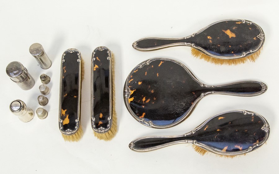 A George V silver and tortoiseshell dressing table brush set comprising, two hair brushes, two