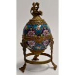 Gilt metal mounted egg box, floral enamel decoration with Putto on dolphin finial.Height approx