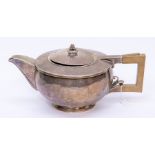 An Art Deco silver melon shaped teapot, planished finish with raised body, rose bud finial and