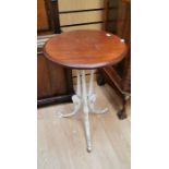 A Victorian cast iron based circular table, the top mahogany, H. 61 cms, Diameter 45 cms.