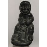 A late 20th Century stone carved figure of an Eskimo on a sledge, inscribed and dated to underside