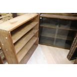 A 20th Century oak glazed cabinet with glazed sliding doors; A pine bookcase (2)