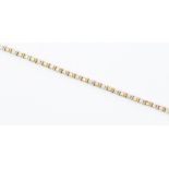 A 9ct gold two tone tennis bracelet, comprising round cubic zirconia set  within alternate white and