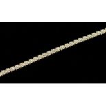 A 9ct gold  tennis bracelet, comprising round white gold links illusion set with small diamonds,