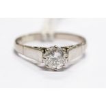 A diamond solitaire 18ct white gold ring, the round brilliant-cut diamond approx 0.66ct, white