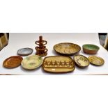 A collection of 19th Century slip ware including bowls, dishes, plates along with a candle holder