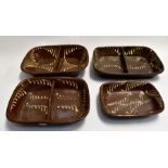 Four late 19th Century to early 20th Century slip ware dishes, brown ground