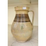 Early 17th Century slip ware water jug, cream ground with decorative collar, part glazed
