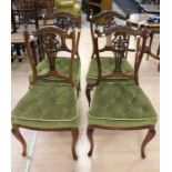 A set of four late Victorian mahogany dining chairs, circa 1890, carved back with green