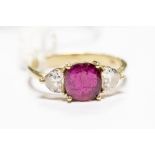 A ruby ring and diamond 18ct gold ring, comprising of round cut ruby claw set to the centre,