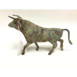 A reproduction metal figure of a bull. 13cm in height. 23cm in length.
