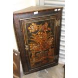 A late 19th century chinoiserie lacquered corner cupboard