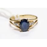 A sapphire and diamond ring, comprising a claw set oval sapphire, measuring approx.. 9mm x 6mm,