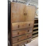 A 20th century oak tallboy, linen cupboard top on four tier chest of drawers