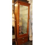 An early 20th Century mahogany wardrobe on a two drawer chest.