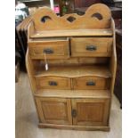 A 20th century pine waterfall shelves on cabinet.