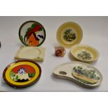 A collection of reproduction Clarice Cliff Wedgwood plates and later hand painted Clarice Cliff