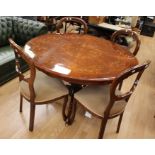 A 19th Century French style mahogany dining table with four balloon back chairs. table with a