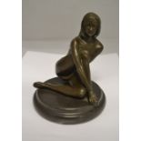 A bronze nude on a black Jasper plinth, unsigned, height approx. 18cm.