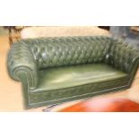 A mid 20th Century green leather Chesterfield three seater sofa, button back with scrolled arms.