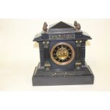 A black marble clock, unknown maker, complete with pendulum and key, height approx 37 cms, slight