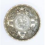 A Chinese white metal circular dish, engraved with foliage in shallow relief, inset with a Chinese