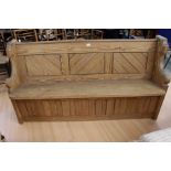 An early 20th century pine church pew.