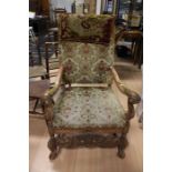 A late 18th/early 19th Century French oak open armchair, rectangular padded back with tapestry