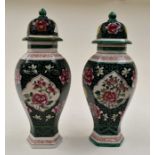 A pair of 20th Century famille rose vases and covers, green and black ground, height approx.