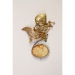 A 9ct gold heart shaped locket on gilt chain, a 9ct gold openwork leaf shaped scroll brooch total