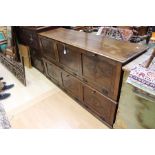 A long oak sideboard cupboard, caned front, drop down compartments, circa mid to late 20th Century