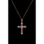 A pink sapphire and diamond 9ct gold cross, comprising square cut channel set sapphires with diamond