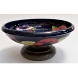 A William Moorcroft 'Hibiscus' pattern bowl, with Tudric pewter base, retailed by Liberty,