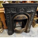 A cast iron bedroom fireplace, complete with fire back and grate