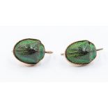 A pair of scarab beetle earrings, unmarked rose metal surrounds on hook fittings,  circa 1920's