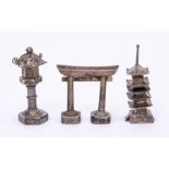 A collection of Japanese style silver models including a pagoda, temple and gateway, stamped