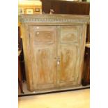 A Victorian pine corner cupboard, moulded dentil cornice, above a two panelled doors opening to