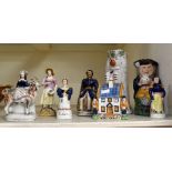 Staffordshire figures including Toby jugs and money box, all 19th Century