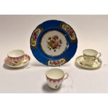 A painted early 19th Century, cups and saucer; 19th Century painted cup and saucer; and a